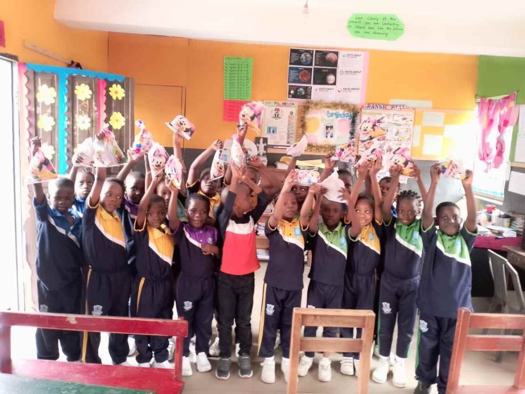 Pupils show off the paper crafts they made in class