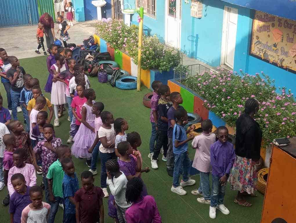 Pupils in a colour-day procession through the courtyard