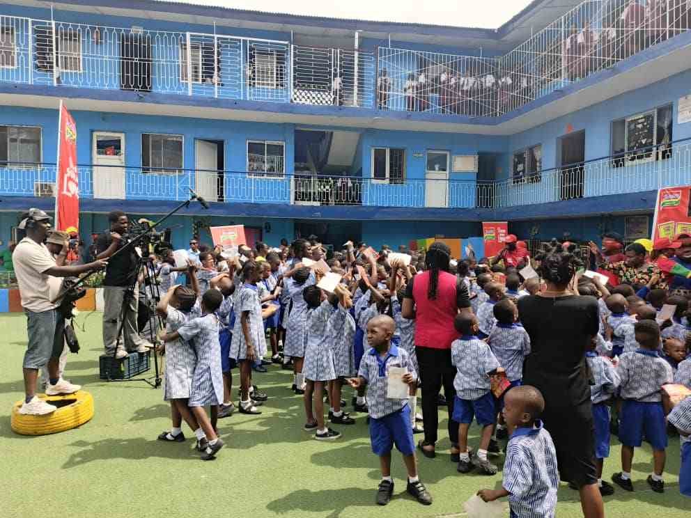 Pupils, teachers and parents at a school event in the courtyard