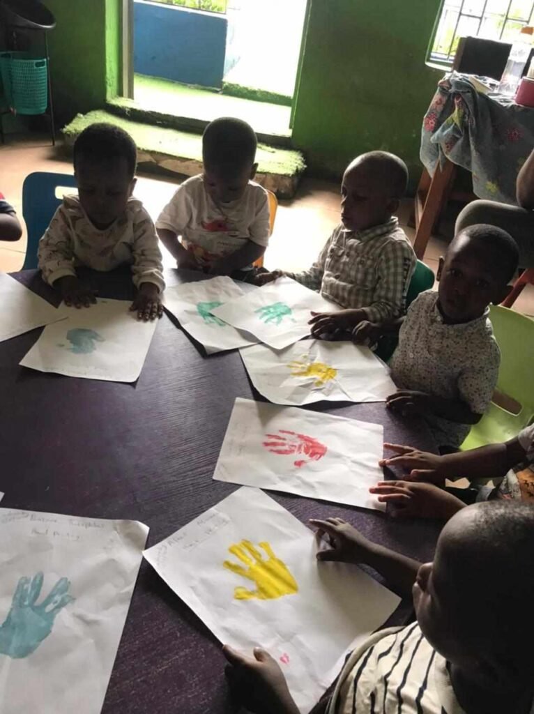 Nursery pupils at a handprint painting session