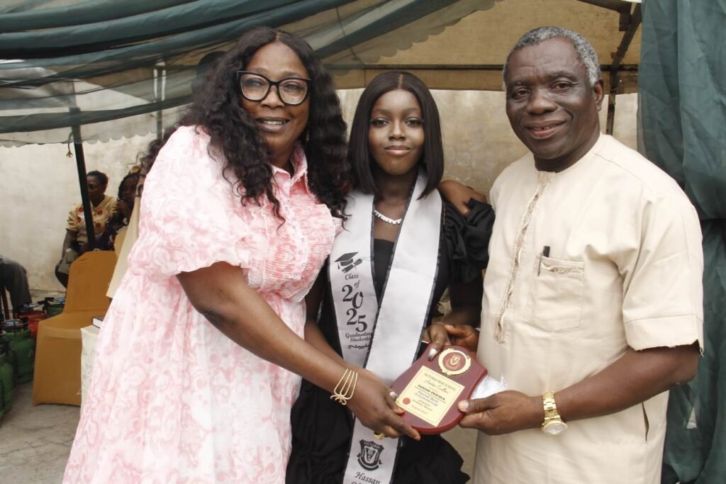 A Victoria High School graduate receiving an award with her parents