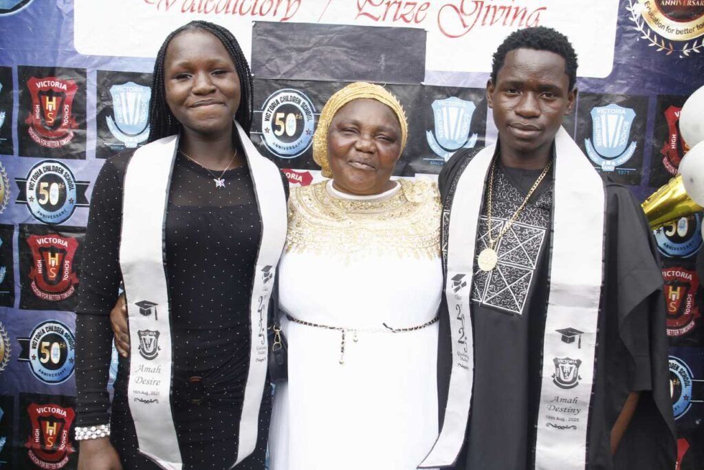 Victoria High School graduates with a parent at the valedictory