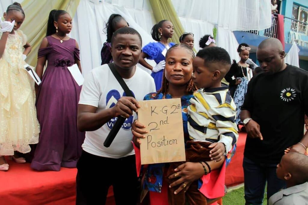 A Victoria Children's School pupil with his prize and parents