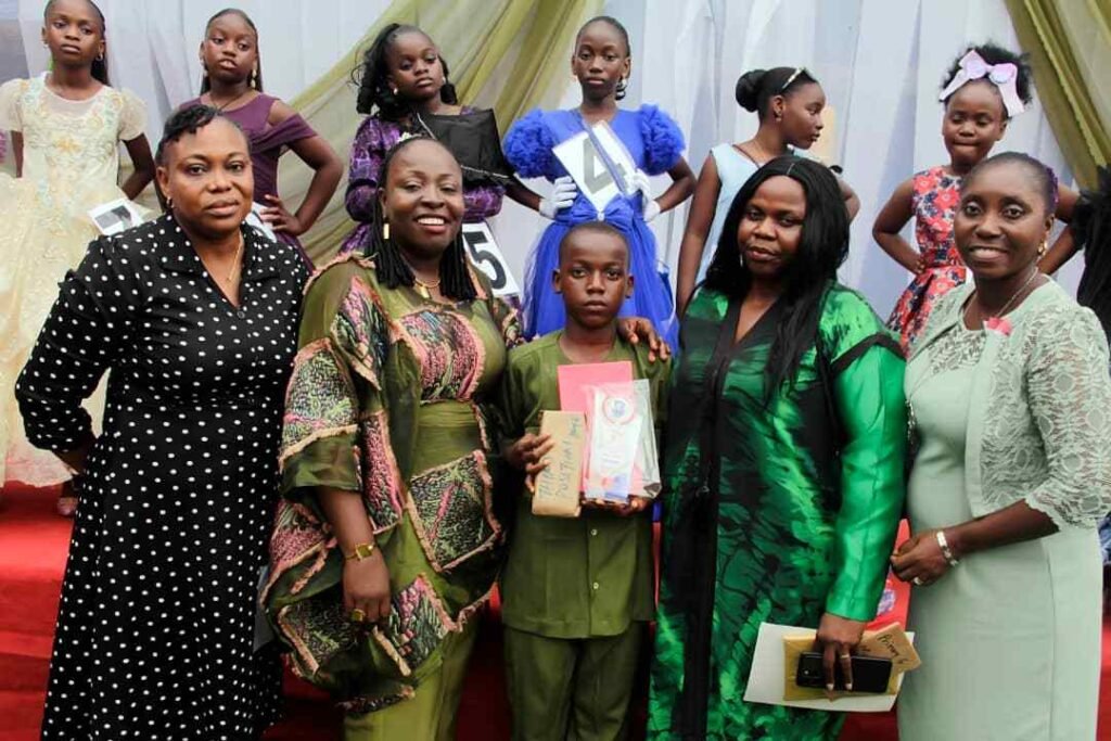 A Victoria Children's School pupil with his prize and family