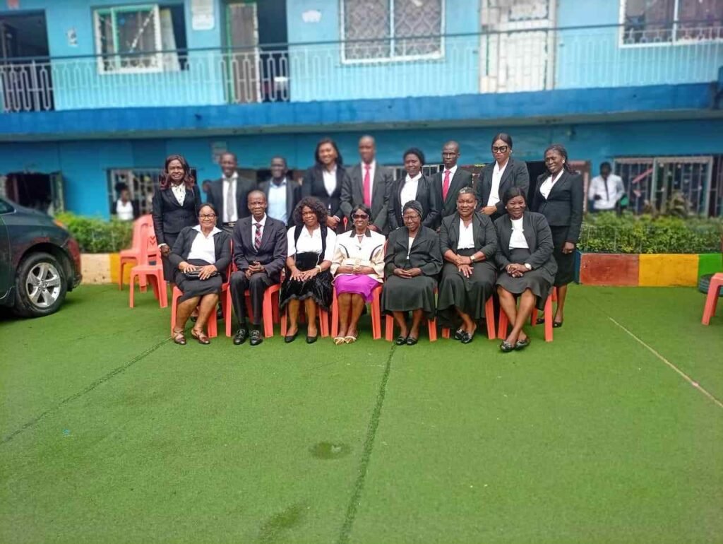 Victoria Schools staff outside the school building in Surulere